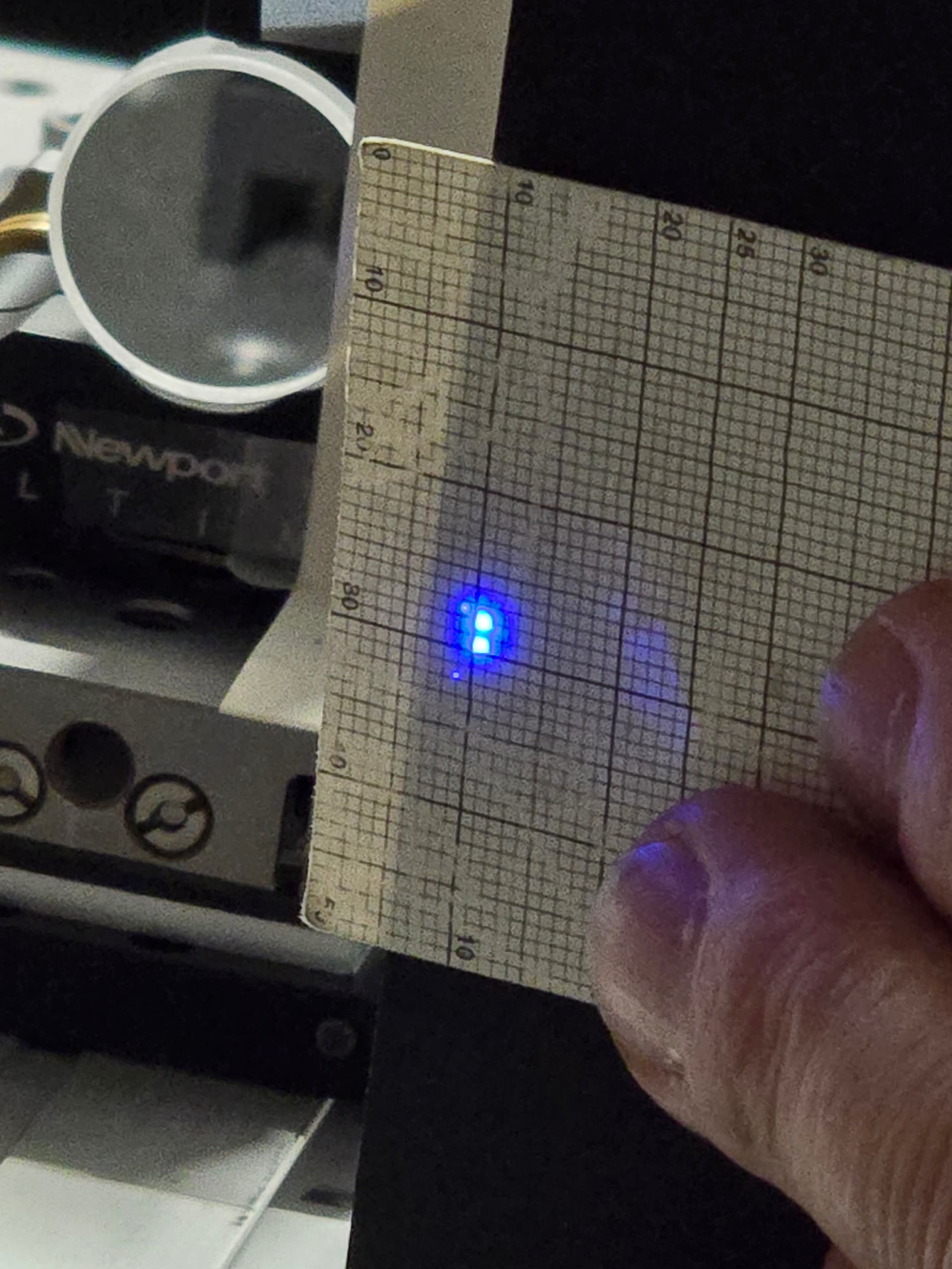 Two small blue ultraviolet spots on a millimetre viewing card