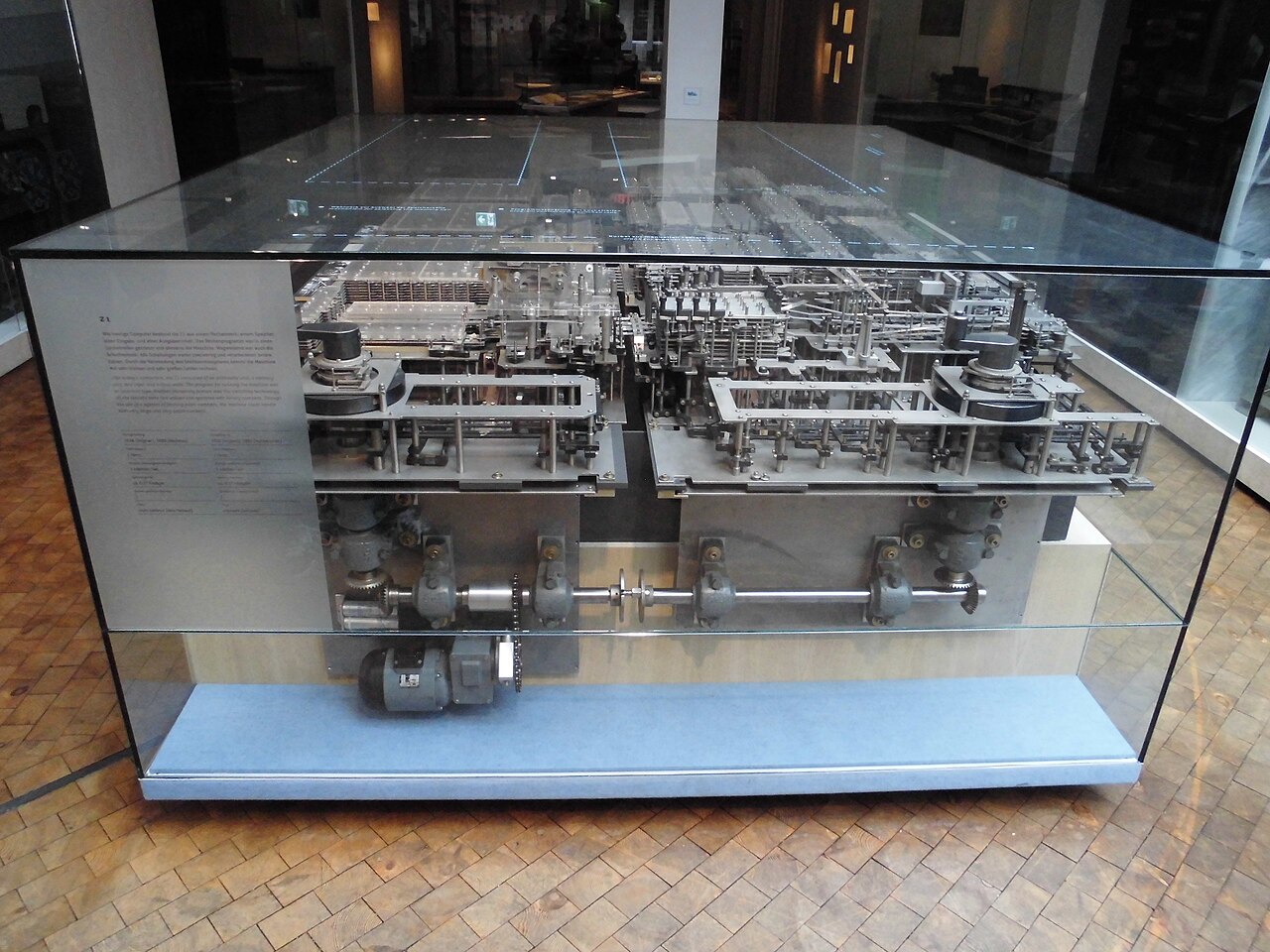 The Z1 replica in a glass case: layers of sheet-metal mechanics above a shaft driven by an electric motor