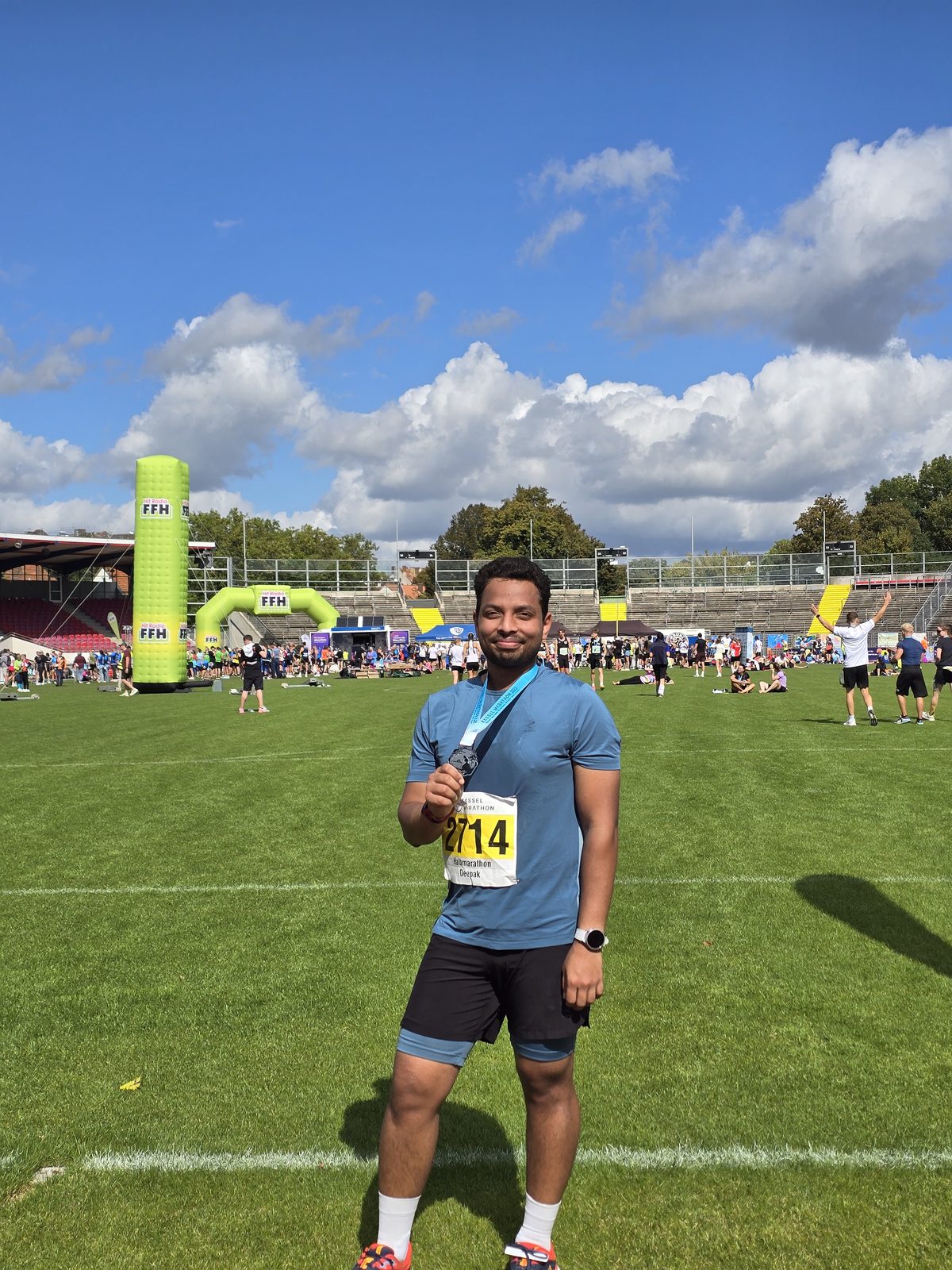 Deepak with his medal after the Kassel Half Marathon 2025, on a sunny day